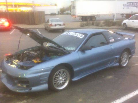 1996 Ford Probe - A blue 1996 Ford Probe is parked with its hood up, revealing the engine compartment.