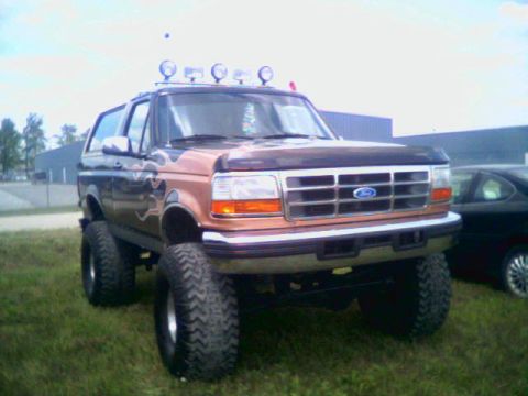 1995 Ford Bronco Eddie Bauer, 3q-front view, lifted with flame decals