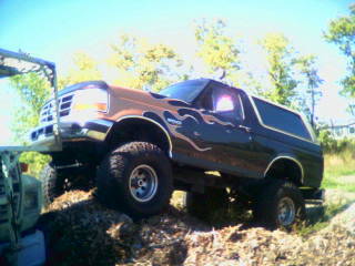 Lifted 1995 Ford Bronco with flame decals, 3q-front view