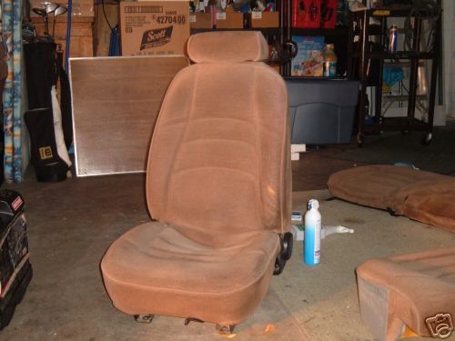 brown velour car seats in a garage setting