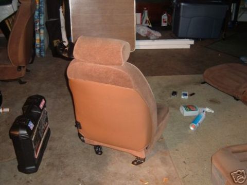 1991 Ford Bronco - A single car seat is shown in a garage setting with cleaning supplies nearby.