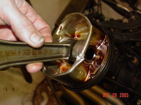 2003 Dodge 1500 - A close-up view of a damaged piston and connecting rod, indicating engine failure.