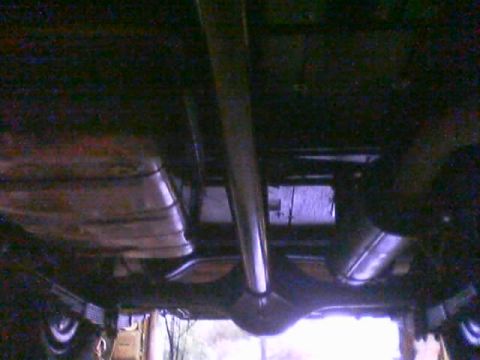 1968 Ford Mustang - The underside of a vehicle is shown, focusing on the exhaust system and rear differential.