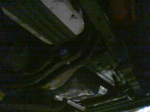 1968 Ford Mustang - A view of the underside of a vehicle, with focus on the exhaust system and suspension parts.