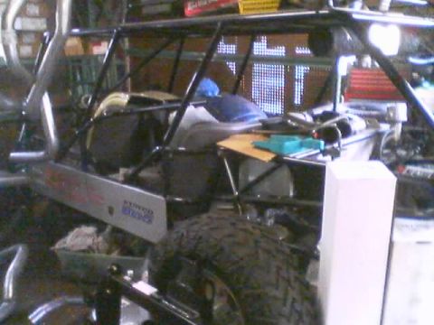 1968 Ford Mustang - A sand rail with a prominent roll cage and a large off-road tire is visible in a workshop setting.