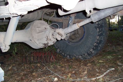 1987 Ford Bronco - Underside view of a vehicle's rear axle assembly and driveshaft.