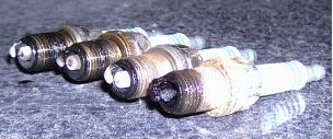 1997 Ford Taurus - Plugs from the front bank. #5 cylinder has suffered some sort of failure looking at the plug.
