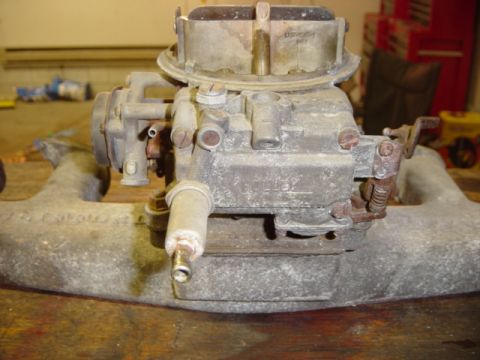 1991 Ford Bronco - Close-up of a Holley carburetor assembly, likely for a V8 engine, on a workbench.