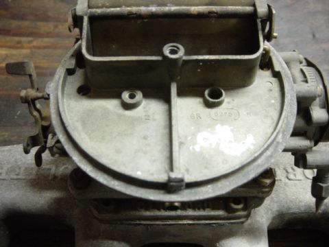 1991 Ford Bronco - Close-up view of a carburetor, a critical engine component for fuel delivery.