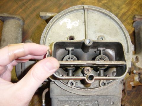 1991 Ford Bronco - Carburetor part shown with a hand adjusting linkage. No vehicle visible.