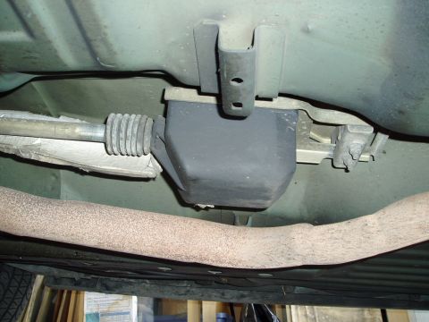 1995 Ford Taurus - Close-up view of a vehicle's undercarriage components, including a rubber boot and exhaust system.
