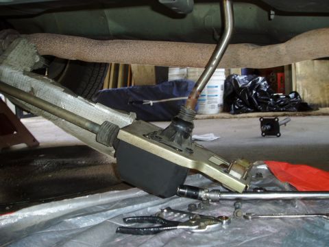 1995 Ford Taurus - Undercarriage view of a vehicle's shifter assembly and exhaust system with tools laid out.