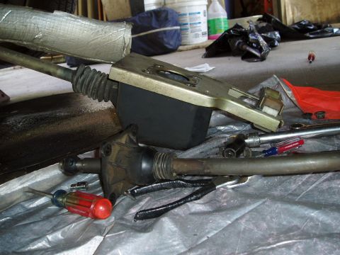 1995 Ford Taurus - Disassembled steering column components are laid out on a plastic tarp, with various tools nearby.