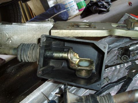 1995 Ford Taurus - Close-up of an automotive shifter linkage part, showing metal and plastic components.