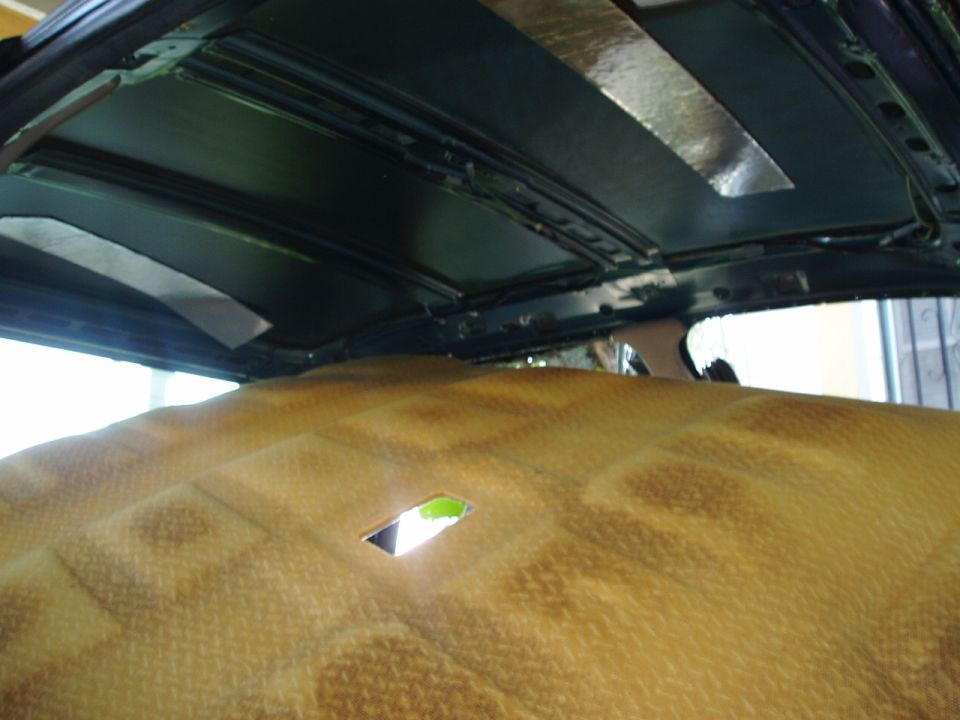 Interior headliner and sun visor of SUV viewed from rear seat looking up