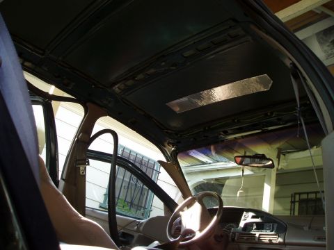 1995 Ford Taurus - The interior headliner of a vehicle is shown, with insulation material applied to a section.