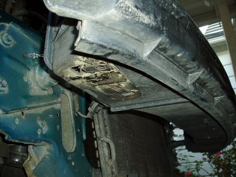 1995 Ford Taurus - Close-up view of the front underside of a vehicle, revealing structural components and wear.