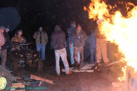1976 GMC C/K Pickup - People stand around a bonfire with an ATV nearby.