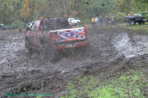 1976 GMC C/K Pickup - Pickup truck engulfed in mud during an off-road event.