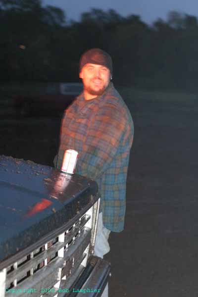 1976 GMC C/K Pickup - Man stands next to the front grille of a GMC C/K pickup truck, likely from the 1973-1974 model years.