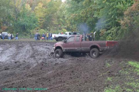 1976 GMC C/K Pickup - Pickup truck stuck in mud during an off-road event.