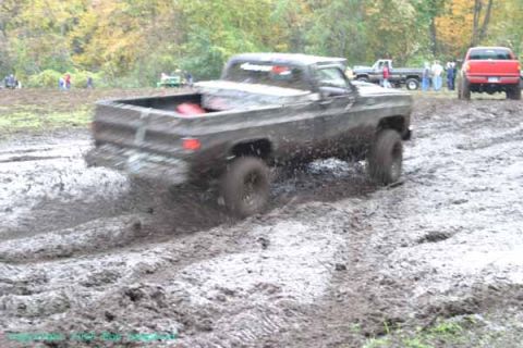 1976 GMC C/K Pickup - Mud bogging event with a 1976 GMC C/K Pickup and other vehicles.