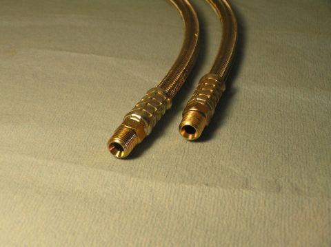 2000 Ford Excursion - Close-up view of two braided hoses, likely for fluid or air transfer, with threaded connectors.