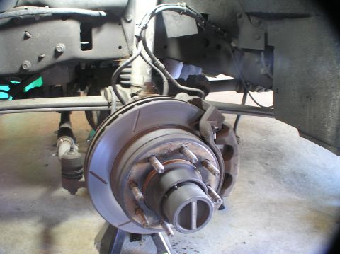 2000 Ford Excursion - Close-up view of a vehicle's front wheel hub and brake assembly, showing the rotor and caliper.