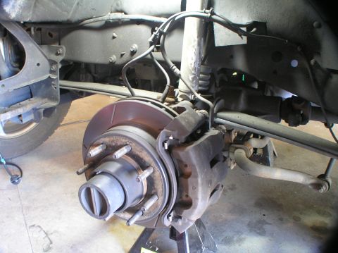2000 Ford Excursion - Rear axle and suspension parts are visible, including brake rotor and caliper.