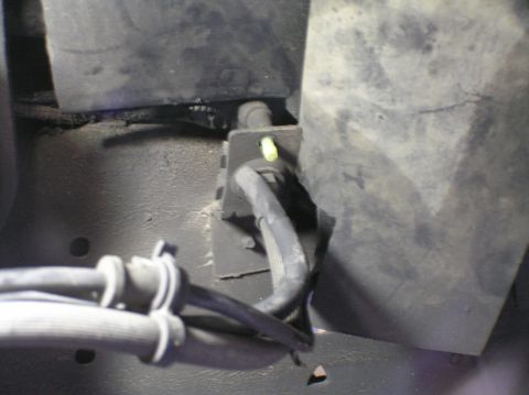 2000 Ford Excursion - Braided brake lines and mounting bracket visible on the underside of a vehicle.