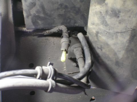 2000 Ford Excursion - This image shows a section of braided hoses and electrical connectors attached to the underbody of a vehicle.