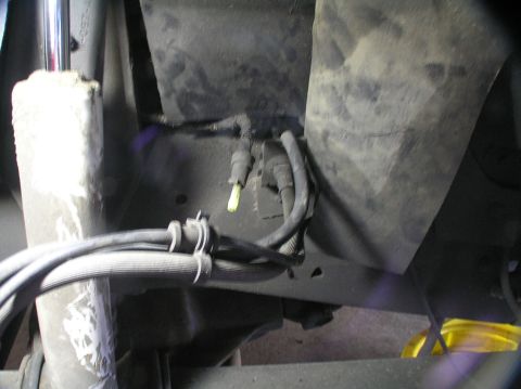 2000 Ford Excursion - Close-up view of the undercarriage, showing various hoses and mechanical parts.