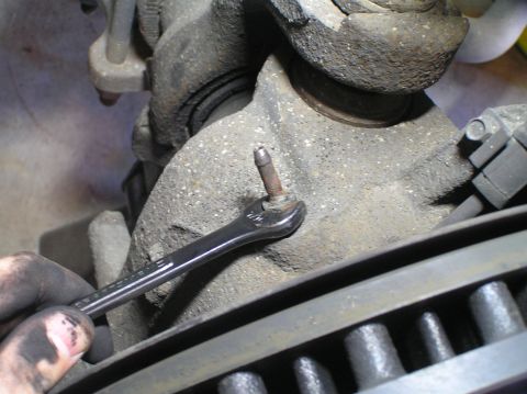2000 Ford Excursion - A wrench is used on a bolt of a vehicle's suspension system.