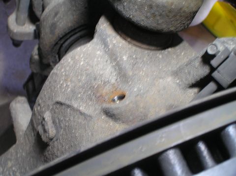 2000 Ford Excursion - Close-up view of a vehicle's brake caliper and rotor assembly, showing mechanical components.