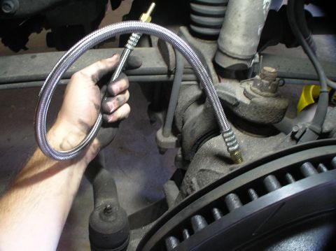 2000 Ford Excursion - Installing a new braided brake line on the front suspension of a vehicle.