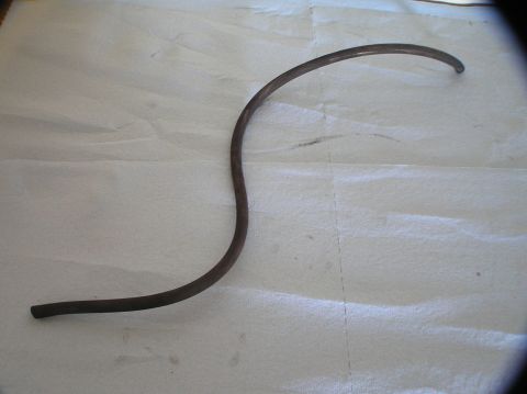 2000 Ford Excursion - A single curved metal tube is shown on a white surface.