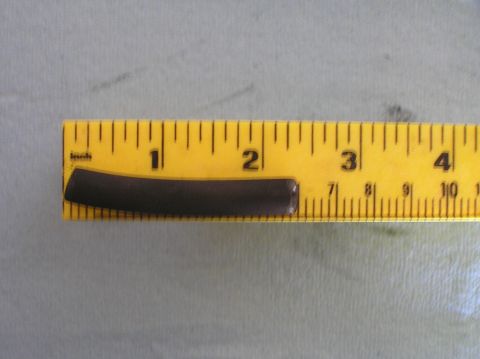 2000 Ford Excursion - A dark hose segment is shown next to a yellow ruler, indicating its length for identification purposes.