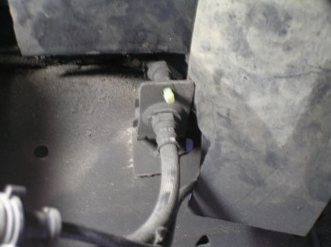 2000 Ford Excursion - Close-up of a braided hose and its mounting bracket.