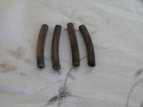 2000 Ford Excursion - Four curved hoses are laid out on a white cloth, showing signs of wear and dirt.
