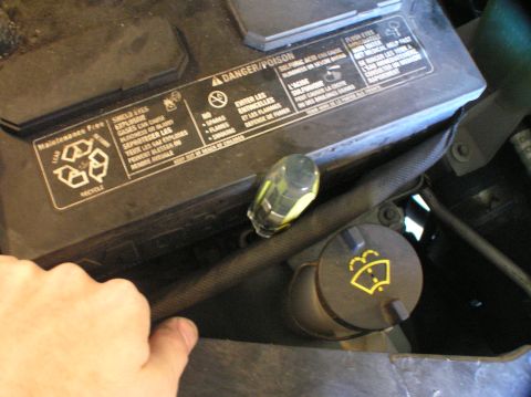 2000 Ford Excursion - A car battery and windshield washer fluid cap are visible in the engine bay.