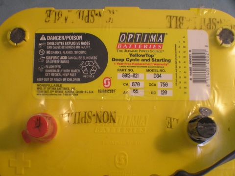 2000 Ford Excursion - A close-up view of an Optima YellowTop D34 battery, showing its labeling and specifications.