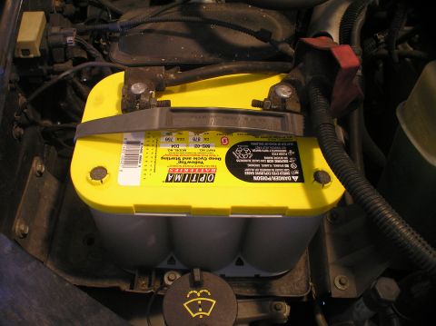 2000 Ford Excursion - A yellow Optima Yellow-top D34 battery is secured in an engine compartment.