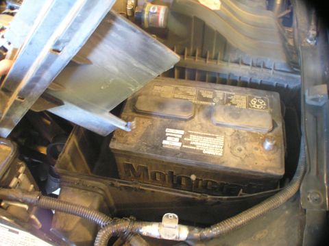 2000 Ford Excursion - A Motorcraft battery is visible in the engine bay, with some of its casing and surrounding components in view.
