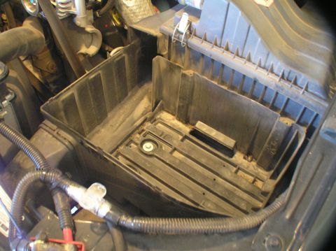 2000 Ford Excursion - An empty battery tray is shown, with no batteries or vehicle visible.