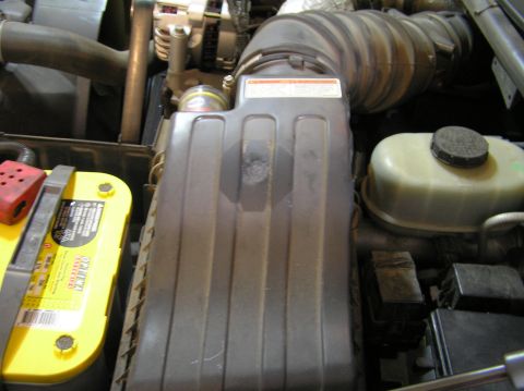 2000 Ford Excursion - Close-up of engine bay components including air intake and battery.