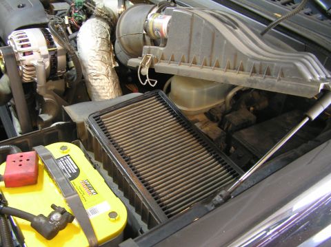 2000 Ford Excursion - Close-up of a vehicle's engine bay, focusing on the air filter and battery components.