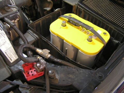 2000 Ford Excursion - Close-up view of a vehicle's engine bay, focusing on the battery and air intake system.
