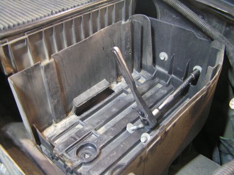 2000 Ford Excursion - Tools are being used to remove bolts from the air intake box, likely for maintenance or replacement.