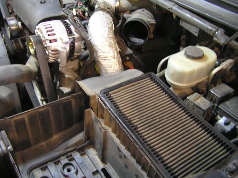 2000 Ford Excursion - Close-up view of an engine compartment, highlighting the air filter and associated components.