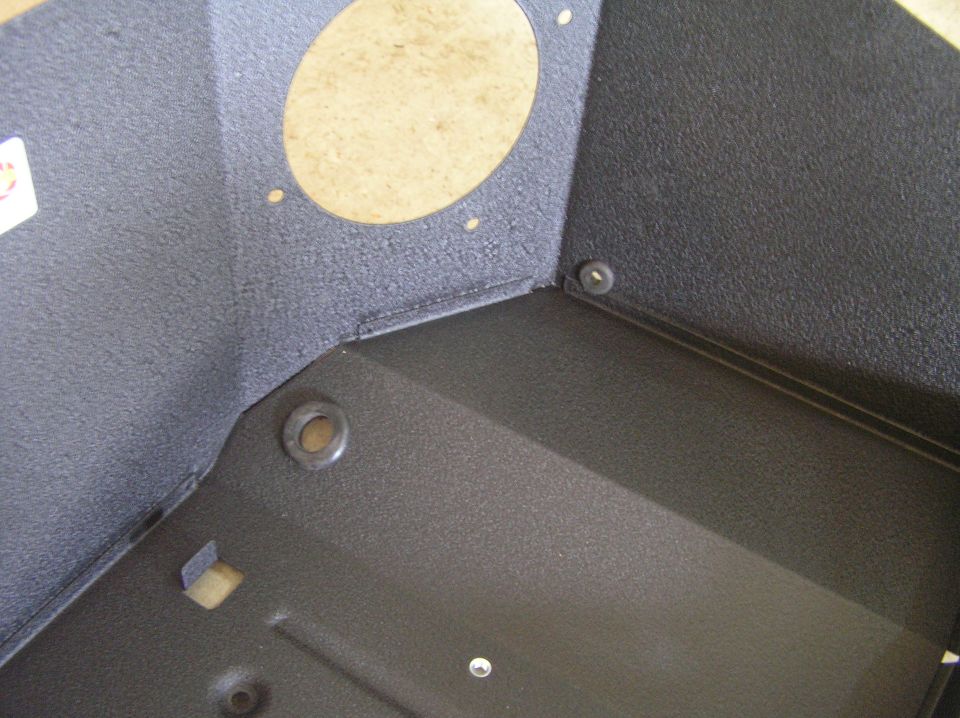 Black carpeted speaker enclosure with round MDF cutout and mounting holes